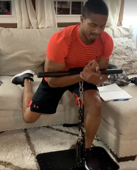 Chrys Johnson performs an Isochain Bulgarian Split Squat with a Zercher Hold