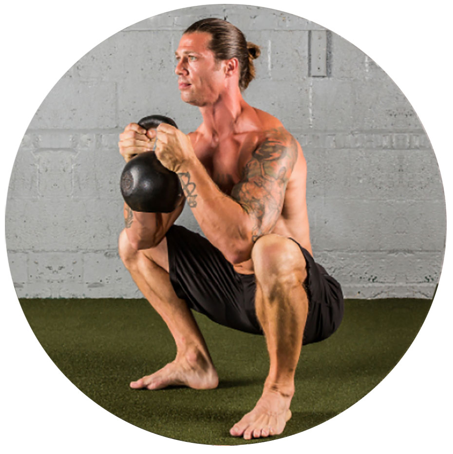 man performing goblet squat with a Dragon Door RKC Kettlebell