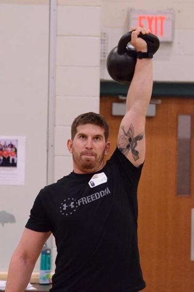 Anthony Moro Presses a Kettlebell Overhead at the RKC Workshop
