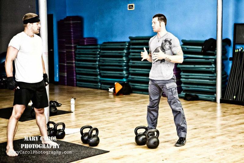 Robert Miller Training Client with Kettlebells at his gym In Kilograms