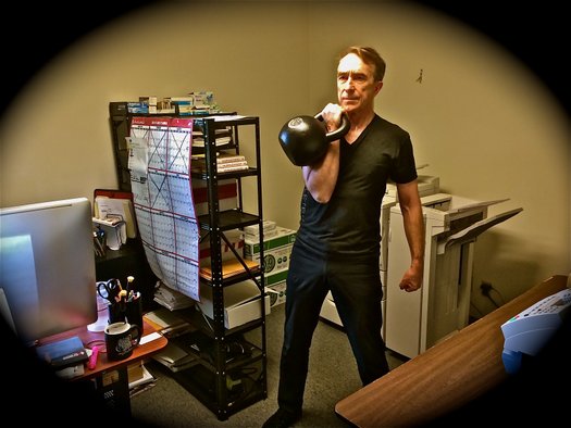 Office Workout John Du Cane performs 30kg kettlebell cleans at the Dragon Door Office