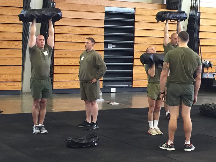Ultimate Sandbag overhead press in military fitness training, tactical training